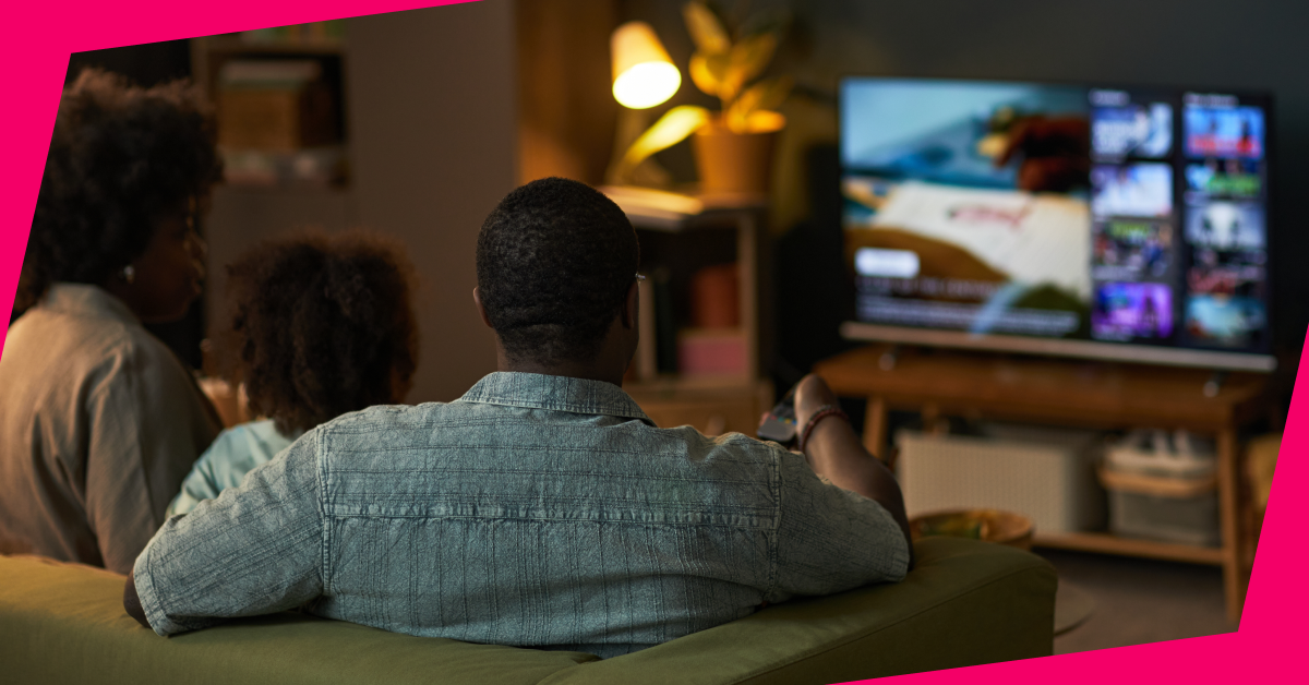 A family sits on a sofa streaming FAST on their connected TV